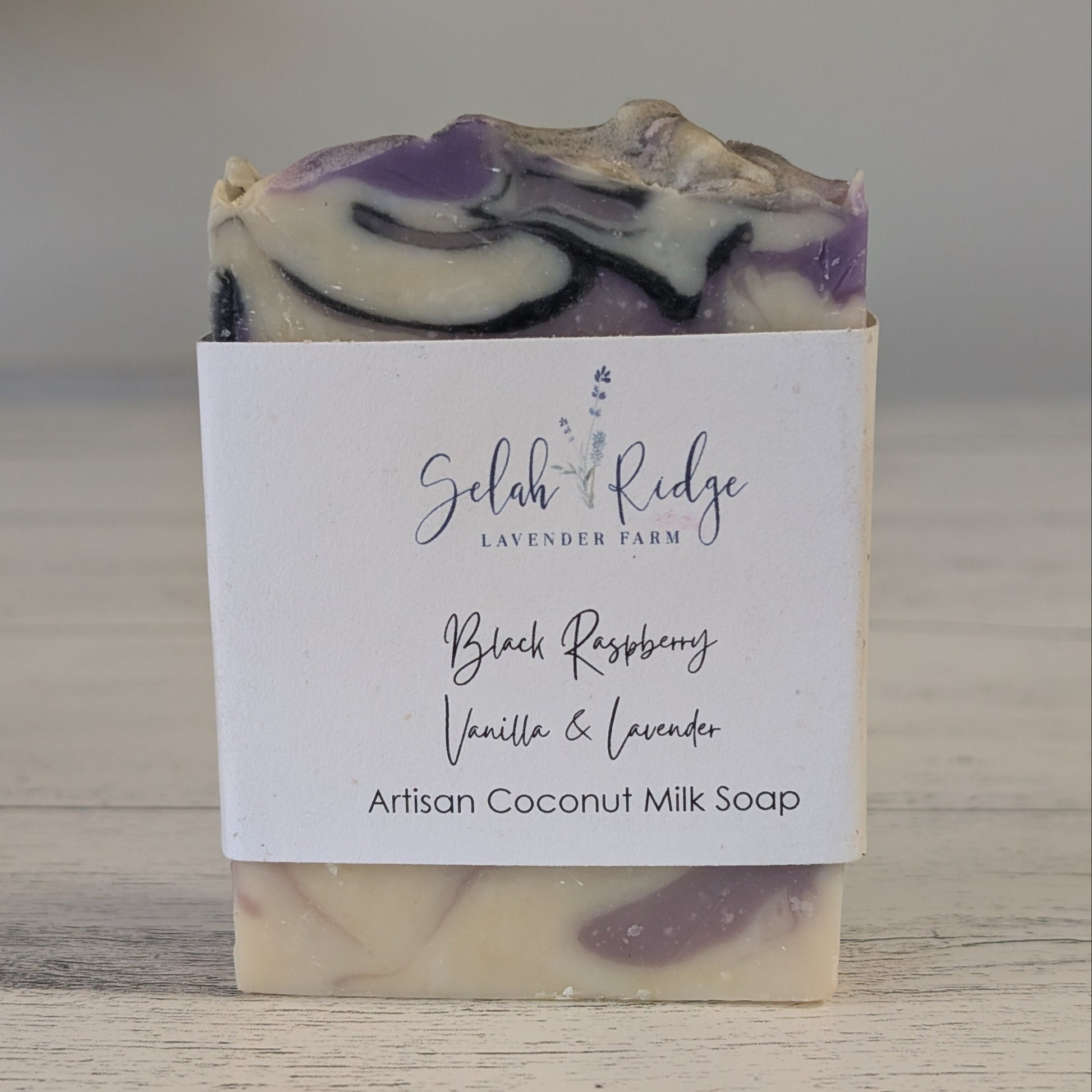 Bar of soap with a label on a wooden surface