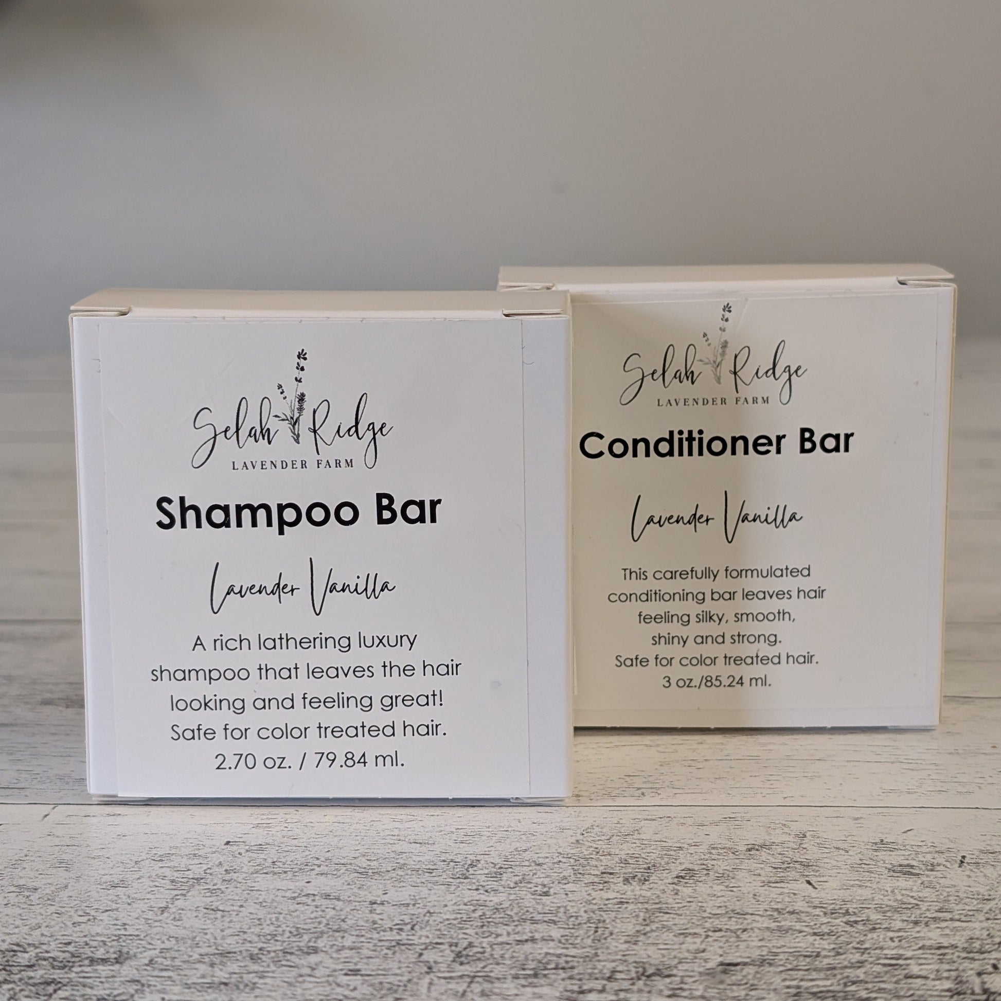 Shampoo and conditioner bars with labels on a wooden surface