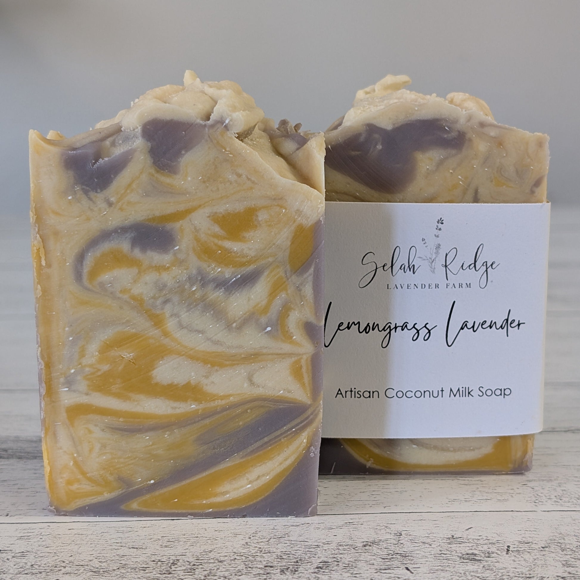 Artisanal soap bar with a visible brand label on a wooden surface