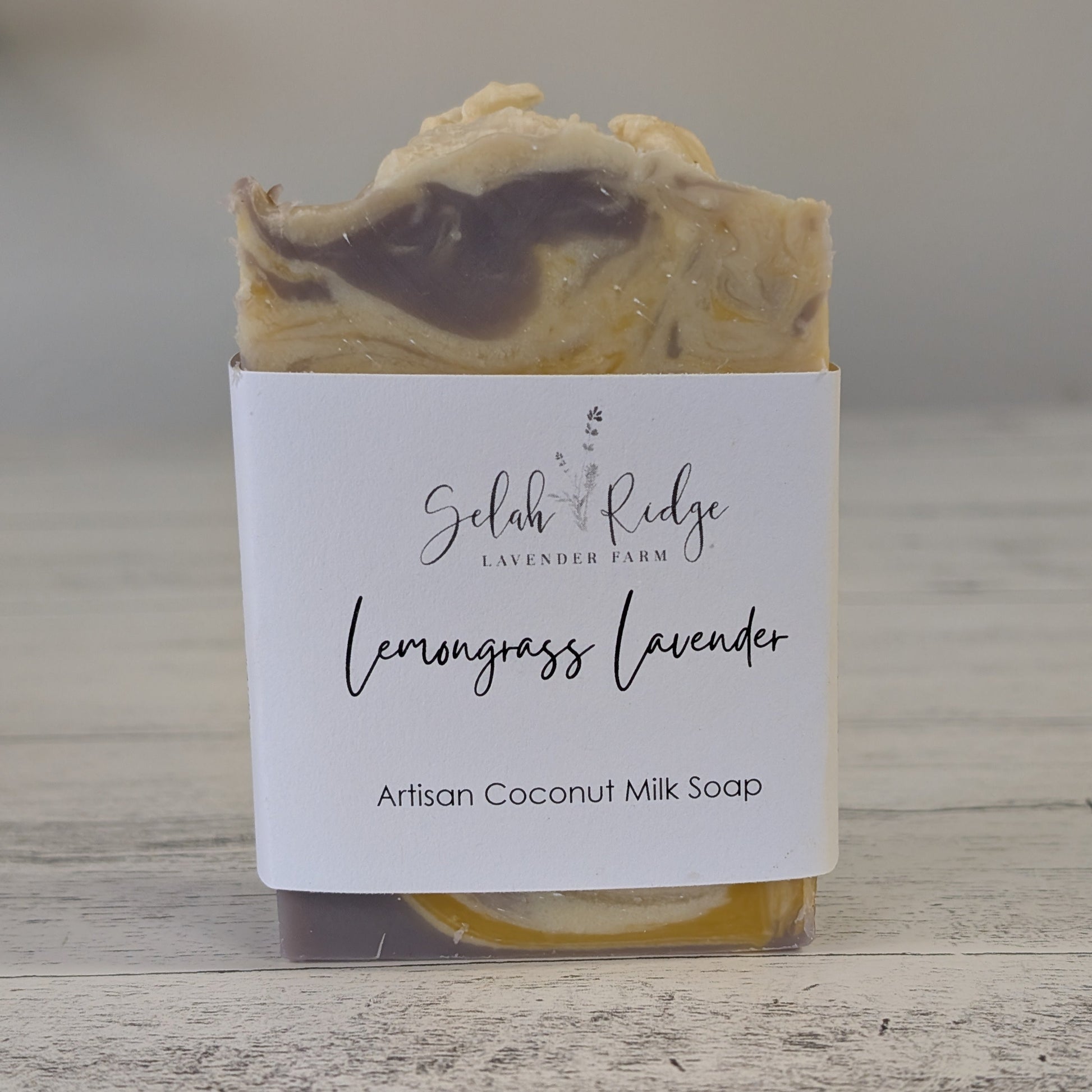 Artisan coconut milk soap with a label on a wooden surface
