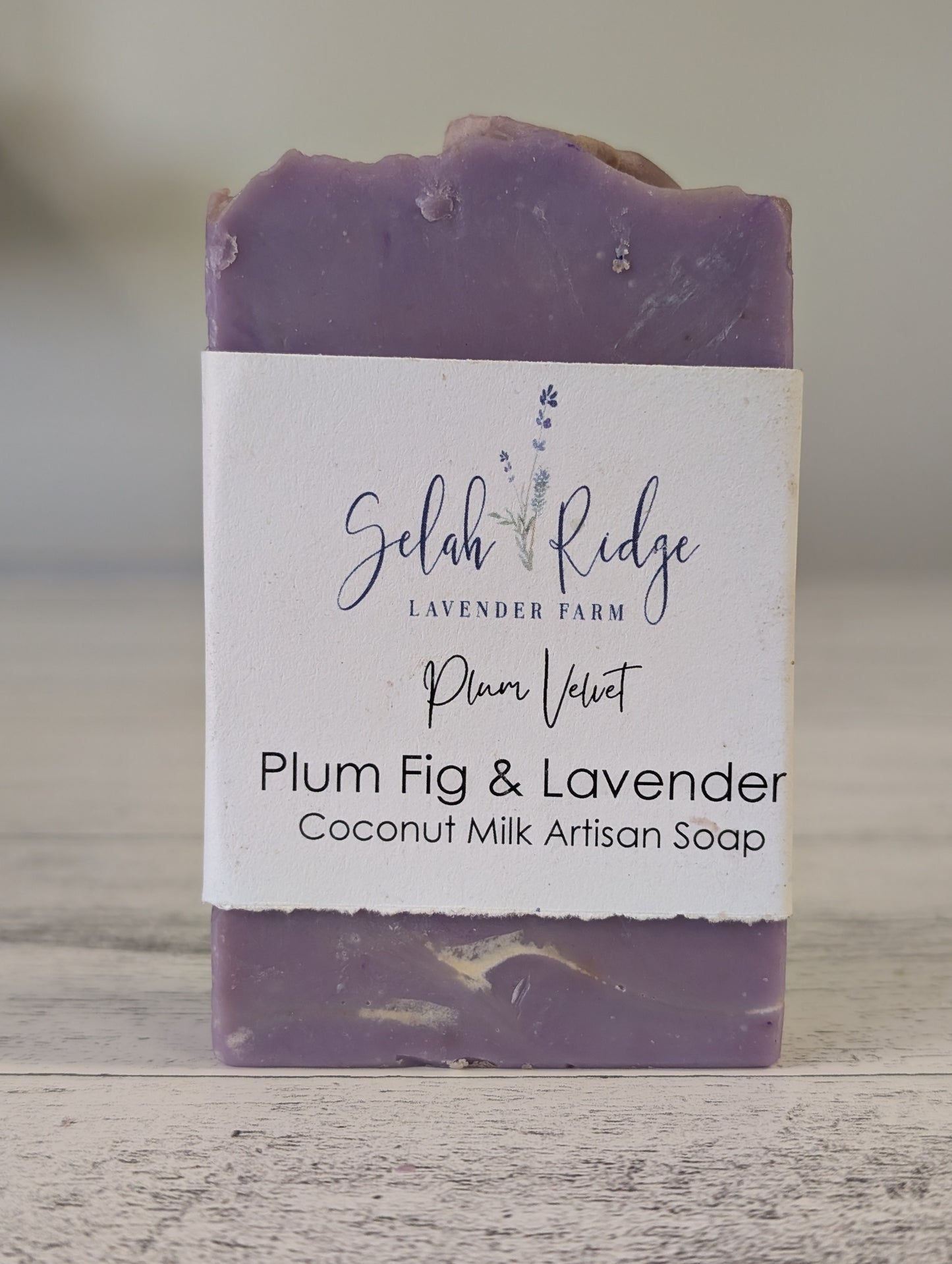 Bar of soap with a label on a wooden surface